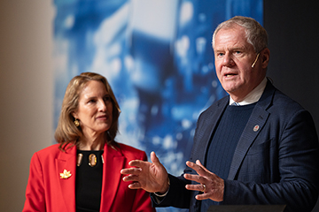 © Deutsche Messe AG. From left to right: Evelyne Coulombe, Chargée d'affaires a.i. for the Embassy of Canada to Germany, and Jayson Myers, CEO of Next Generation Manufacturing Canada, speaking at the HANNOVER MESSE 2025 Press Preview.