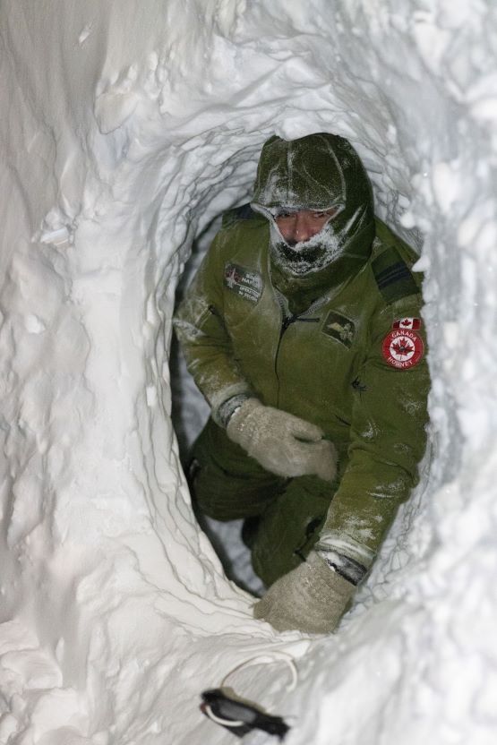 A pilot in a snow shelter.